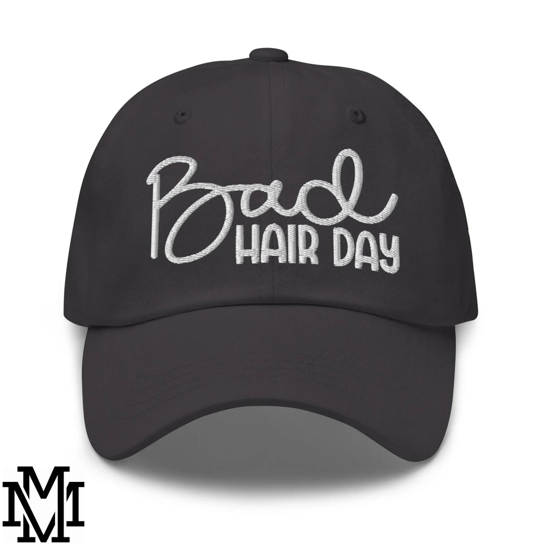 Black baseball cap with white embroidered bad hair day text in cursive and block font for effortless cool style