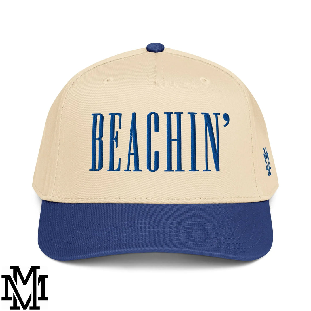 Beige and navy blue baseball cap with bold blue beachin embroidered letters featured in beach serenity article