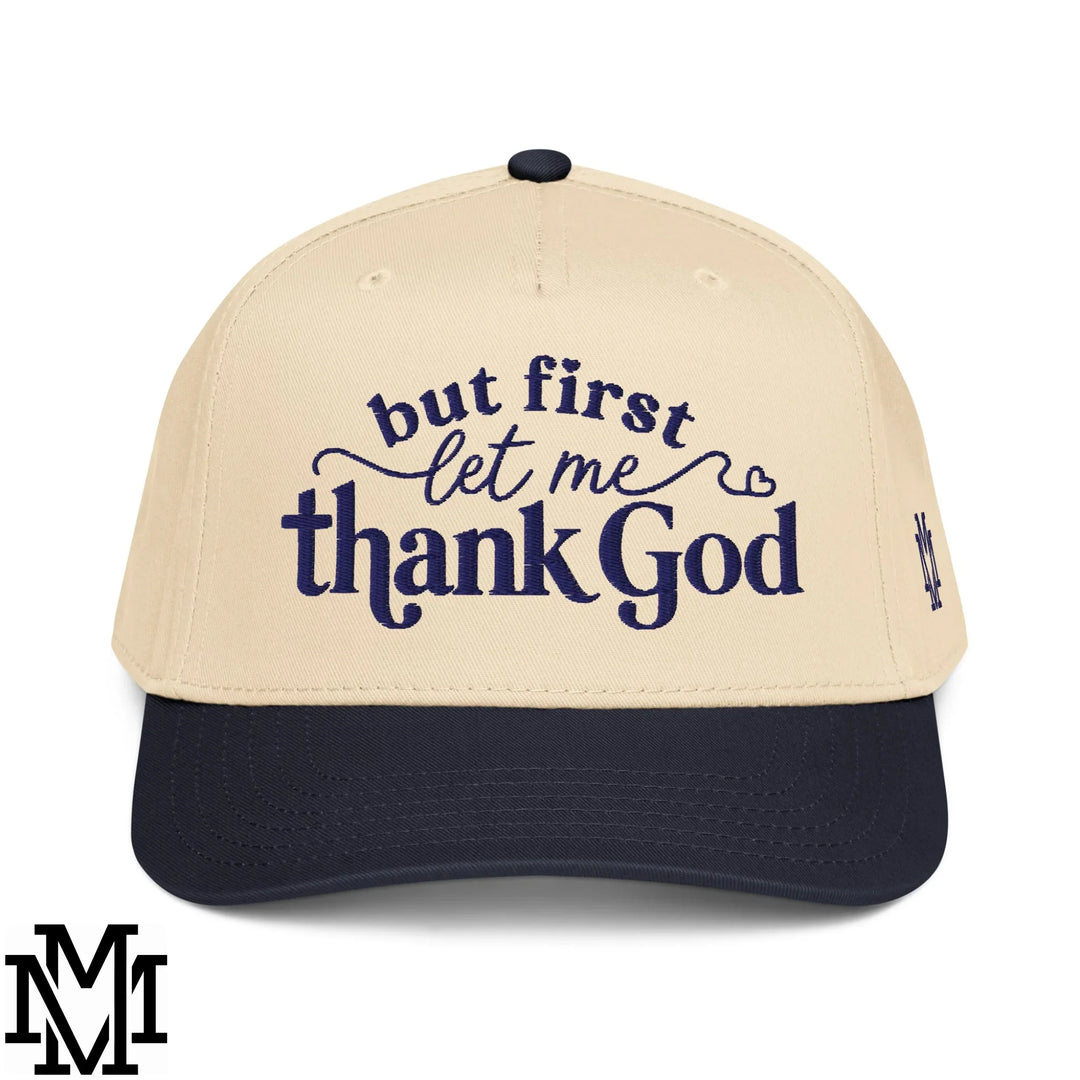 Beige and navy blue baseball cap with embroidered but first let me thank god text in dark blue script for stylish gratitude