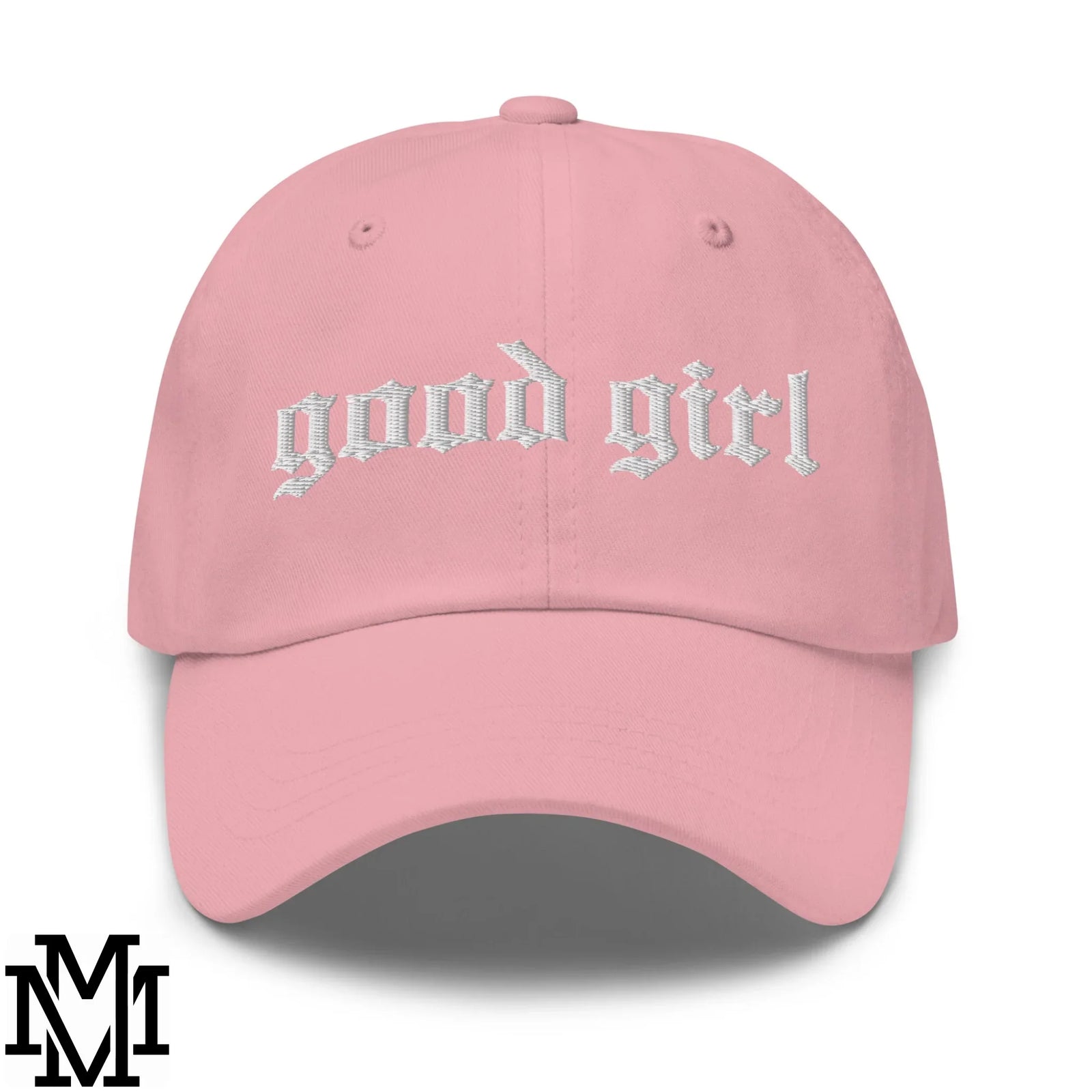 A soft pink unstructured baseball cap with good girl embroidered in white gothic font for everyday elegance