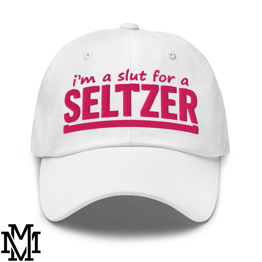 White cotton dad hat with pink embroidered text reading im a slut for a seltzer ideal for playful casual wear