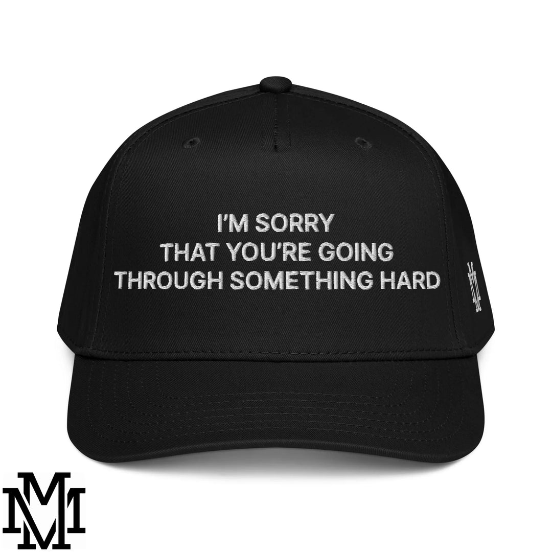 Black baseball cap with white embroidered text im sorry that youre going through something hard and small side logo