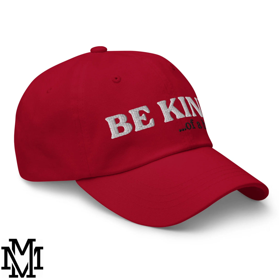 Red unstructured dad hat with be kind embroidered in white thread across the front for casual wear