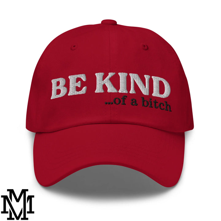 Red unstructured dad hat with be kind of a bitch embroidered in white and black thread