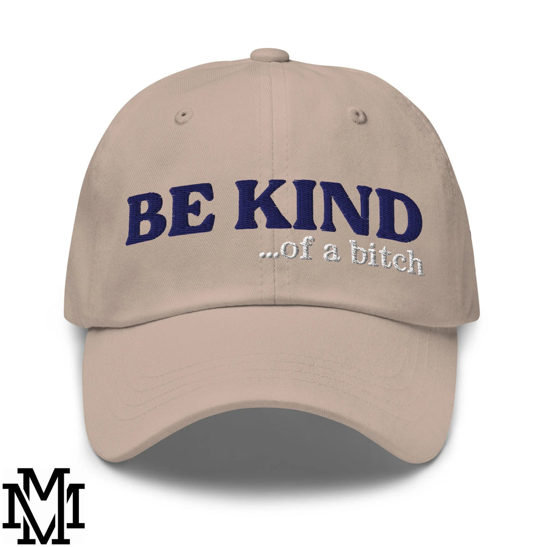 Beige unstructured dad hat with navy blue and white embroidered text reading be kind of a bitch