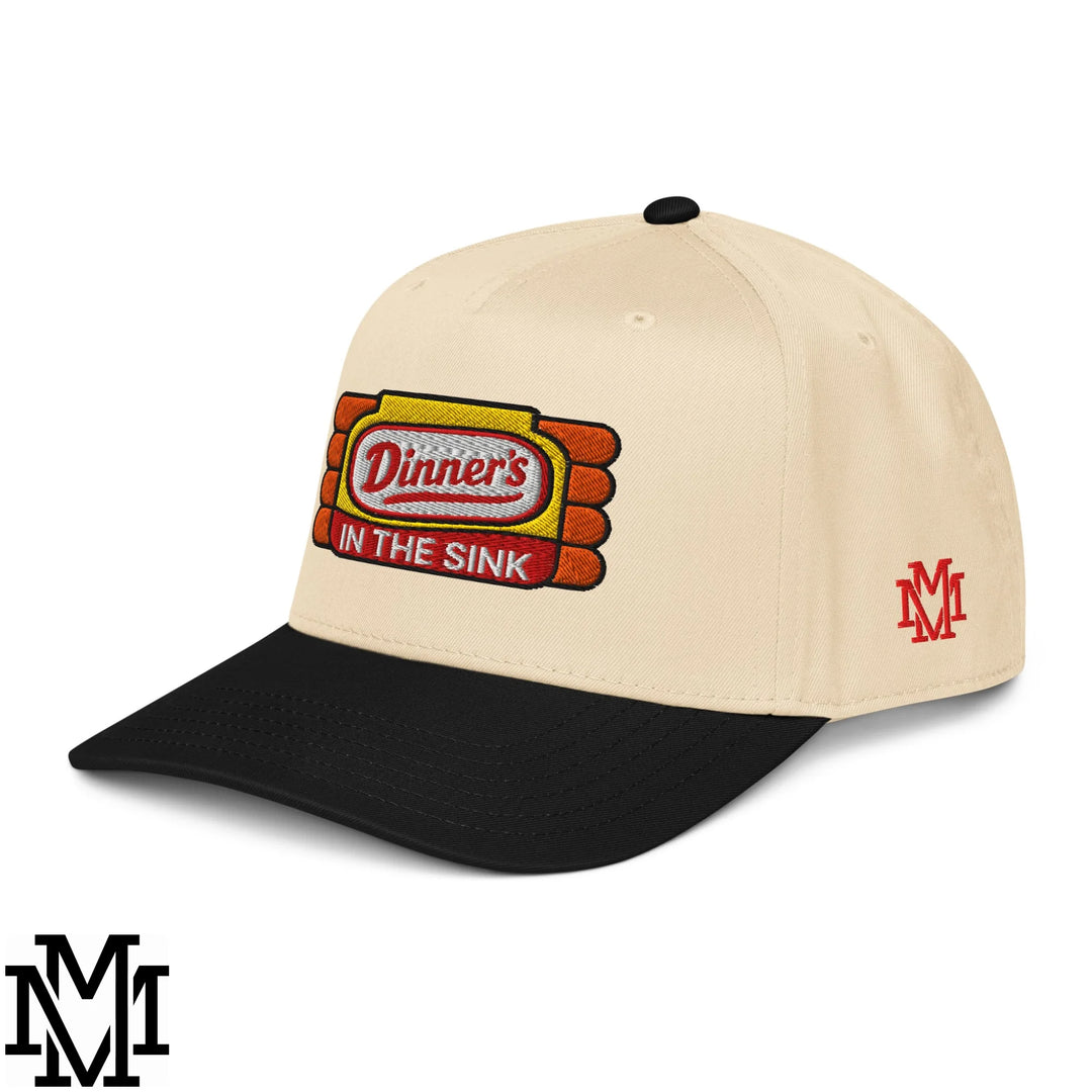 Beige and black baseball snapback hat featuring embroidered dinners in the sink logo with red yellow and white details