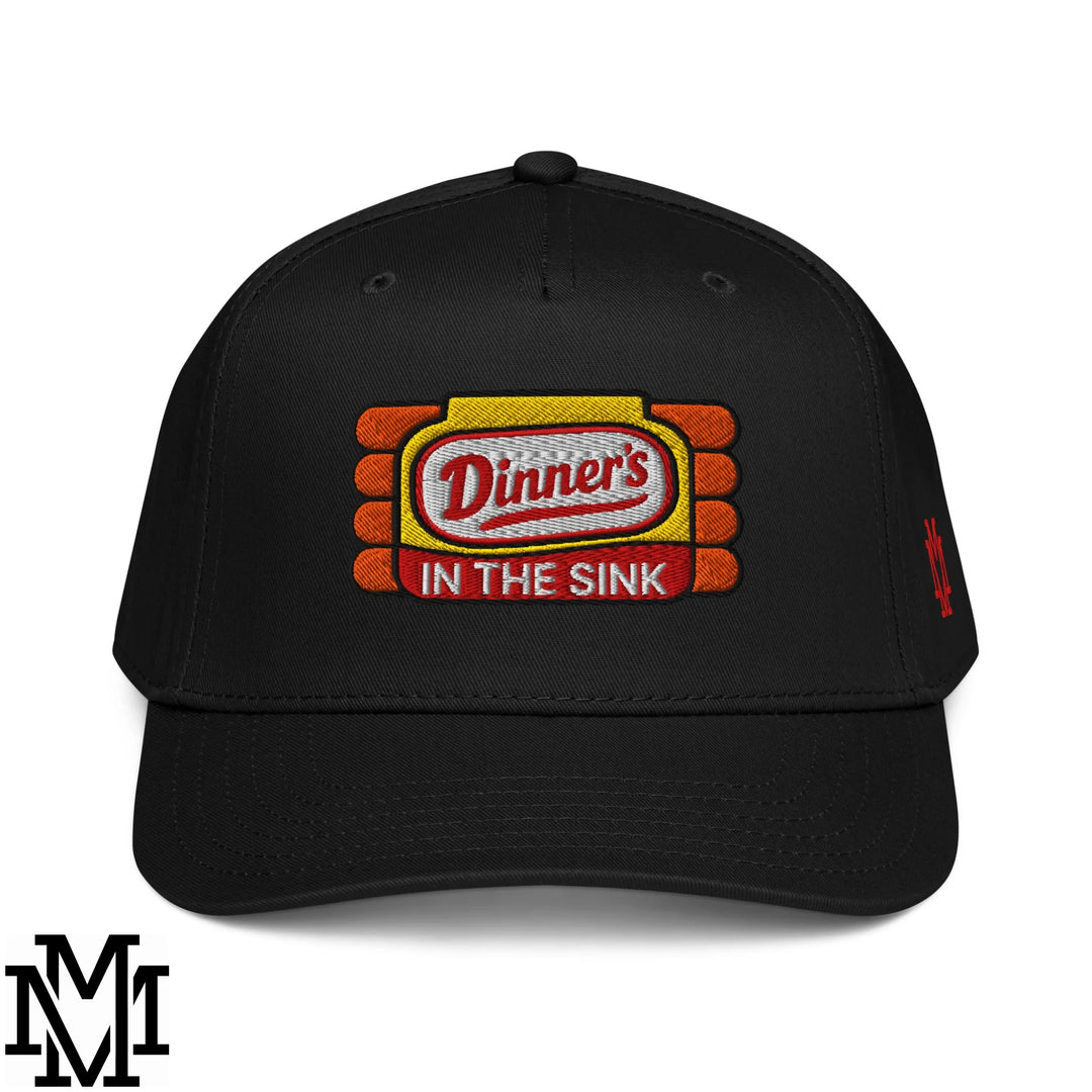 Black baseball snapback hat with embroidered dinner’s in the sink patch in red white on yellow framed by orange bricks