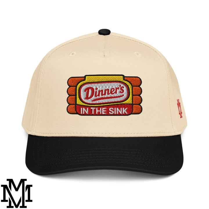 Beige and black baseball snapback hat with embroidered dinner’s in the sink logo in red yellow and white thread