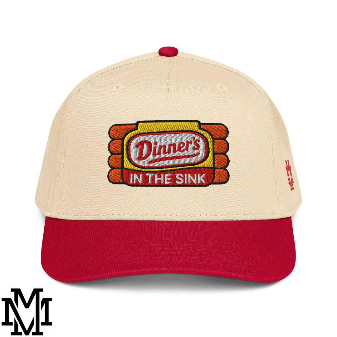 Beige and red baseball snapback hat with embroidered dinners in the sink logo in yellow orange and white thread