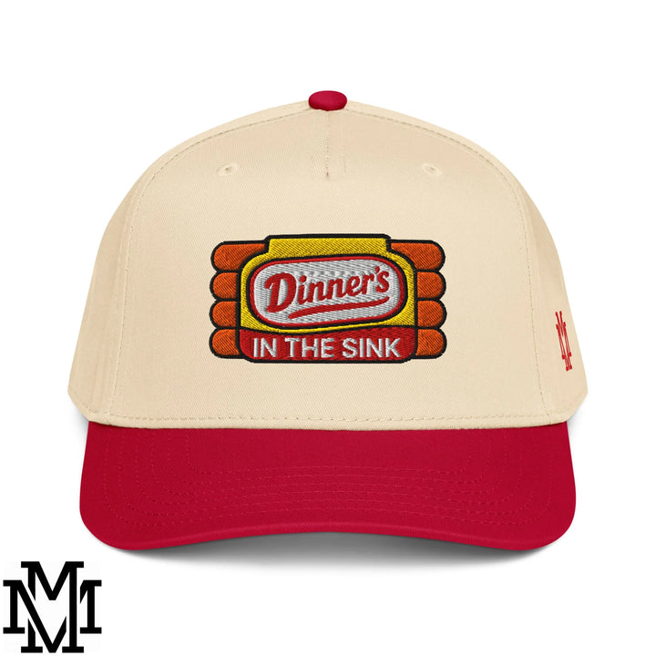 Beige and red baseball snapback hat with embroidered dinners in the sink logo in yellow orange and white thread