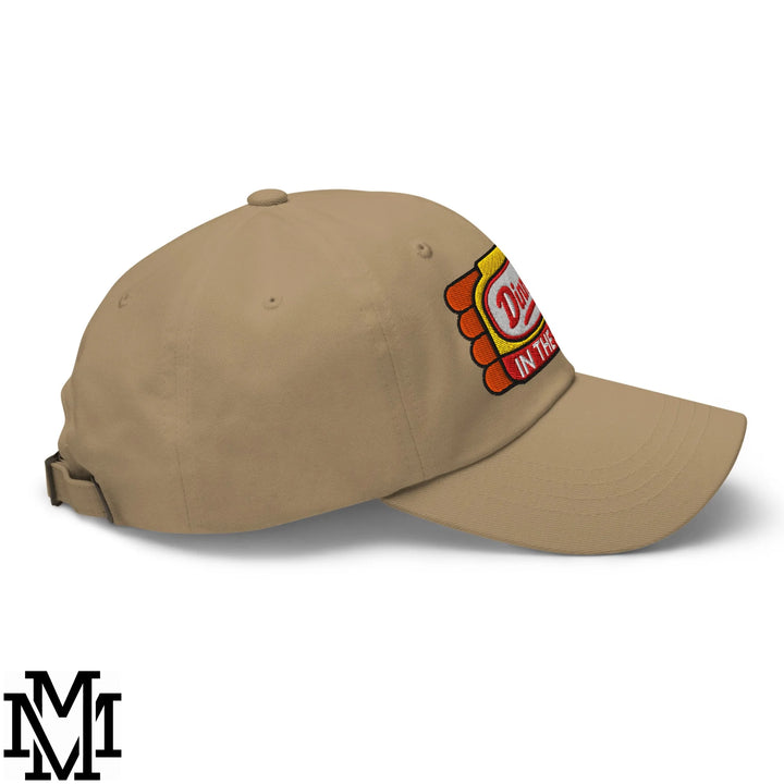 Beige unstructured dad hat with colorful embroidered patch with red yellow and white lettering dinner’s in the sink design
