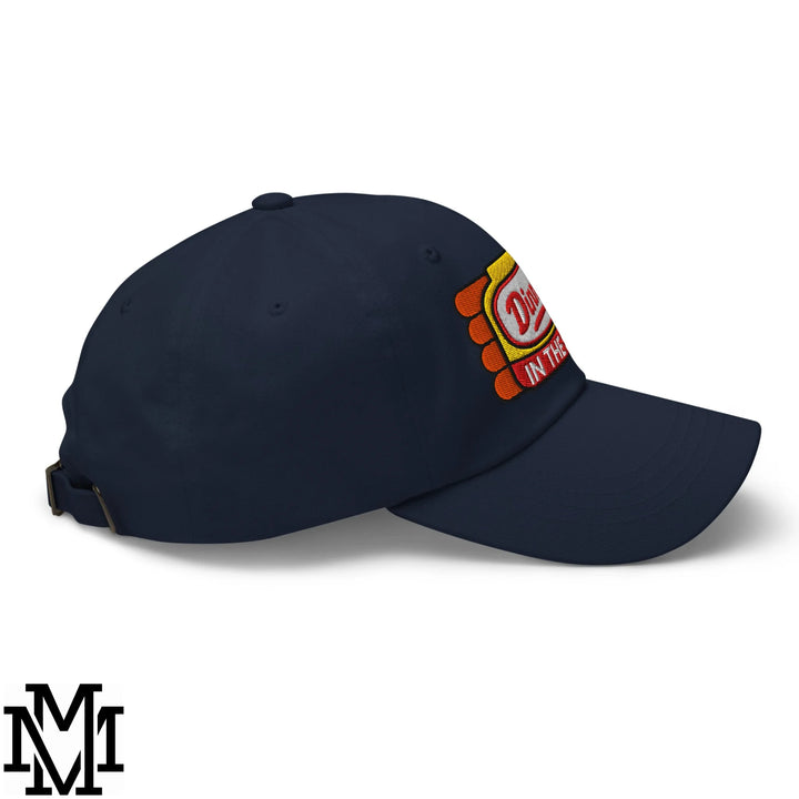 Navy blue unstructured dad hat with colorful embroidered patch reading dirt in the on its side dinner’s in the sink design