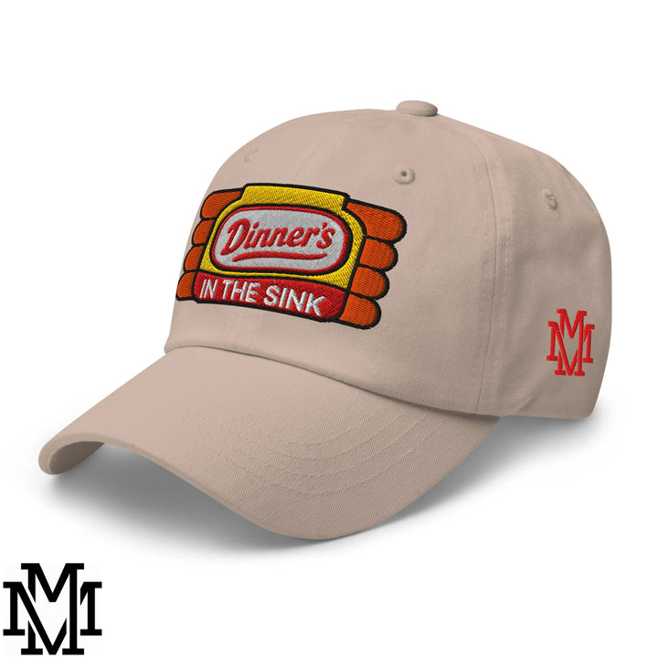 Beige unstructured dad hat featuring embroidered dinner’s in the sink logo with yellow orange and red stitching