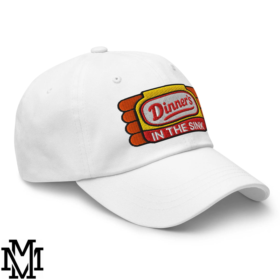 White unstructured dad hat with embroidered vintage diner style dinner’s in the sink patch in red and yellow