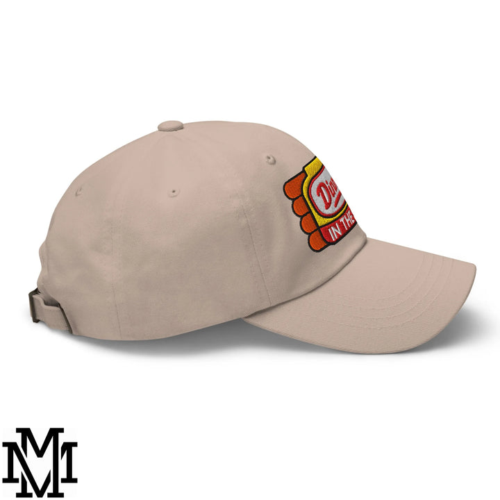 Beige unstructured dad hat featuring a colorful embroidered dinner’s in the sink patch with red yellow and orange tones