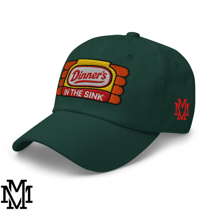 Dark green unstructured dad hat with dinner’s in the sink embroidered logo in yellow orange and red stitching