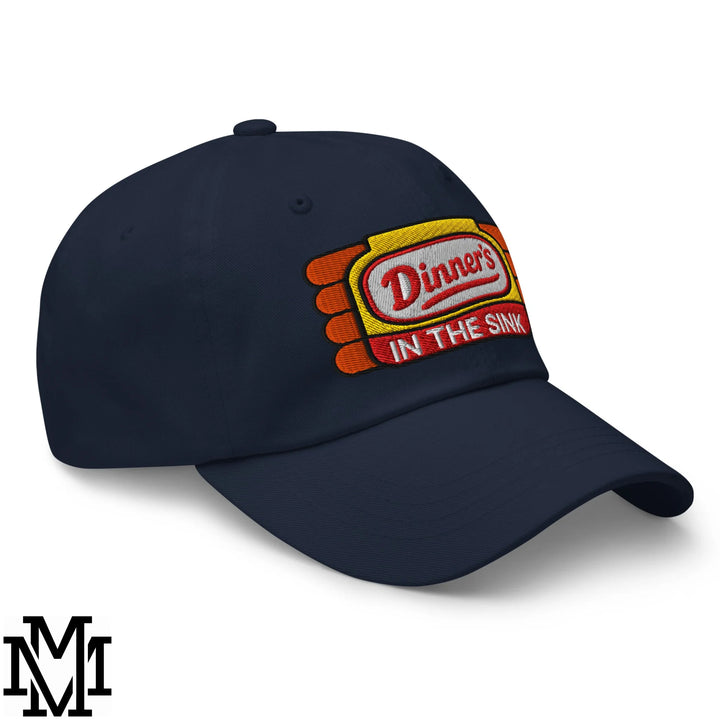 Navy blue dinner’s in the sink embroidered unstructured dad hat with a colorful patch on the front panel