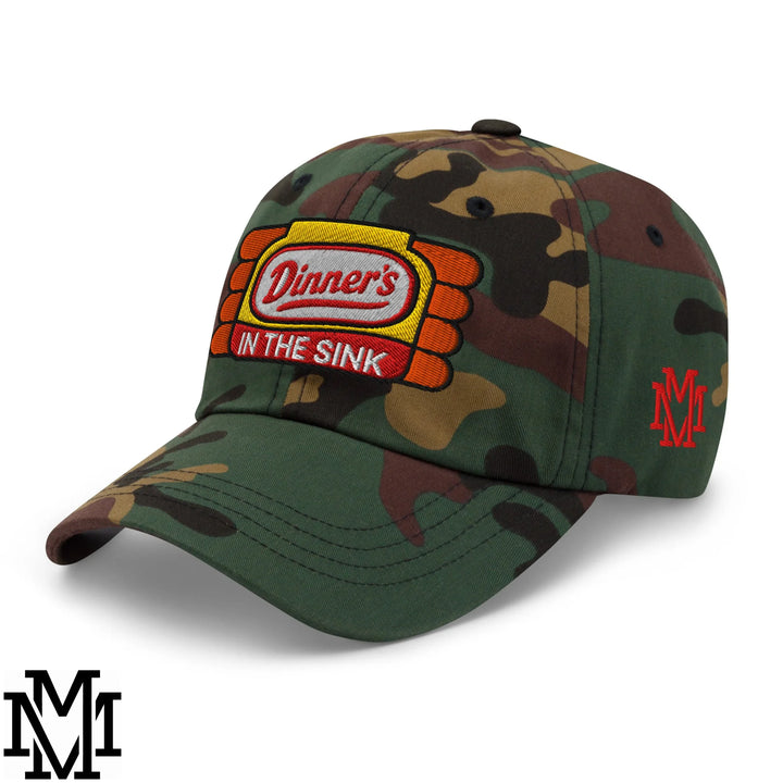 Camouflage unstructured dad hat with embroidered dinner’s in the sink patch and orange yellow red accents