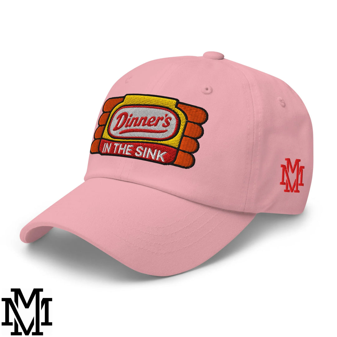 Pink Dinner’s in the Sink embroidered unstructured dad hat with yellow orange logo and red mm brand mark on the side