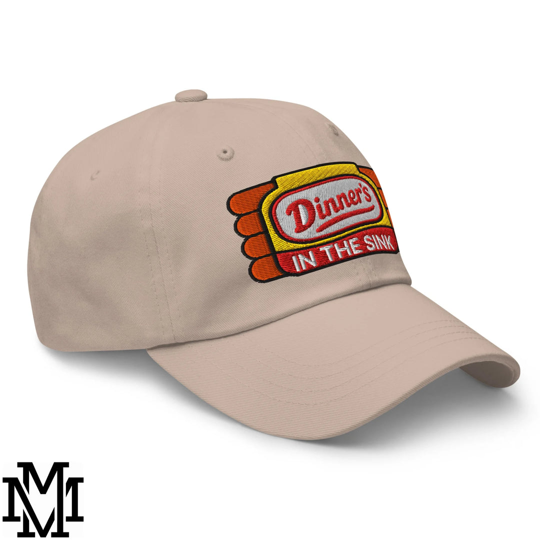 Beige dinner’s in the sink embroidered unstructured dad hat with red white and yellow patch logo