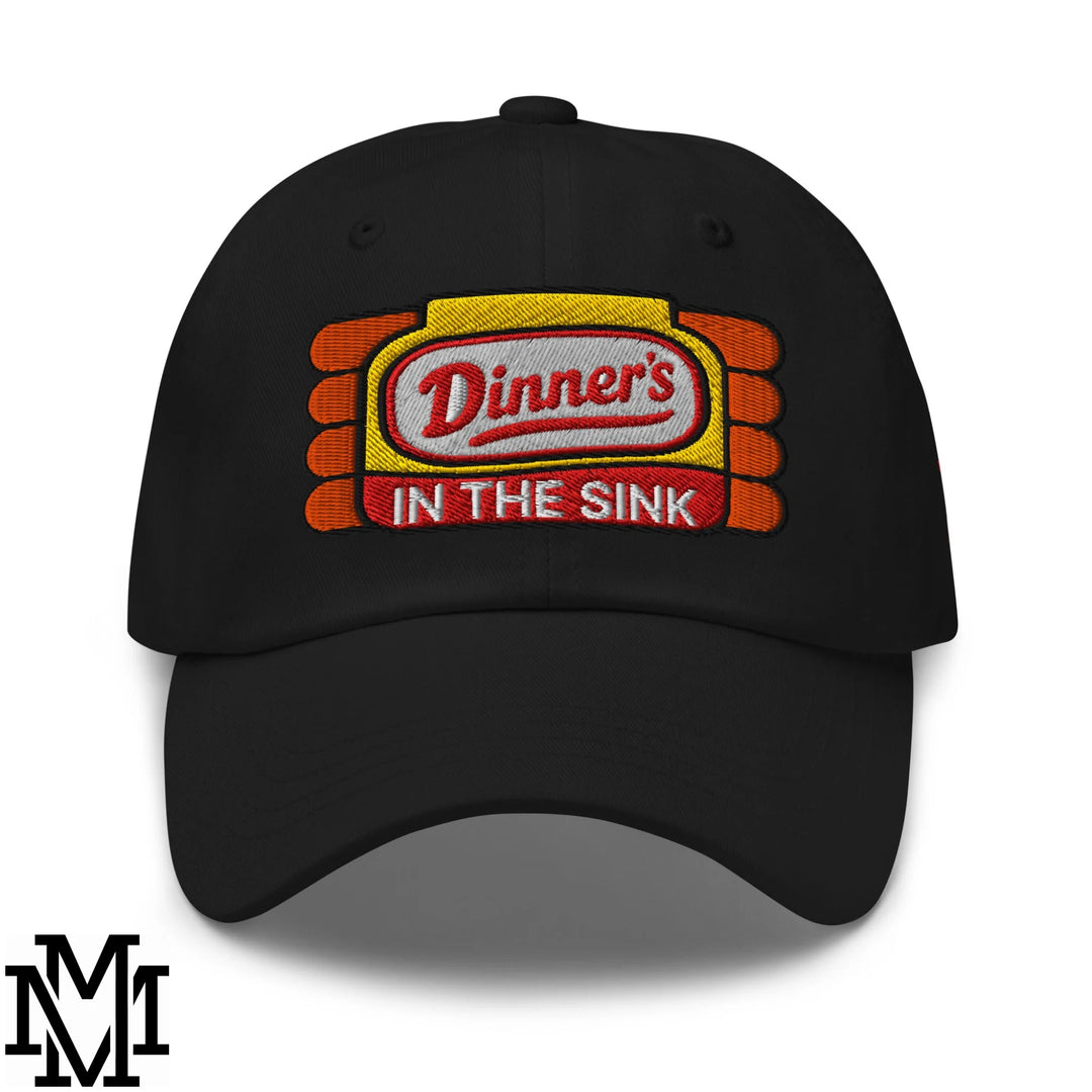 Black embroidered unstructured dad hat with yellow and orange ketchup bottle logo and red dinner’s in the sink text