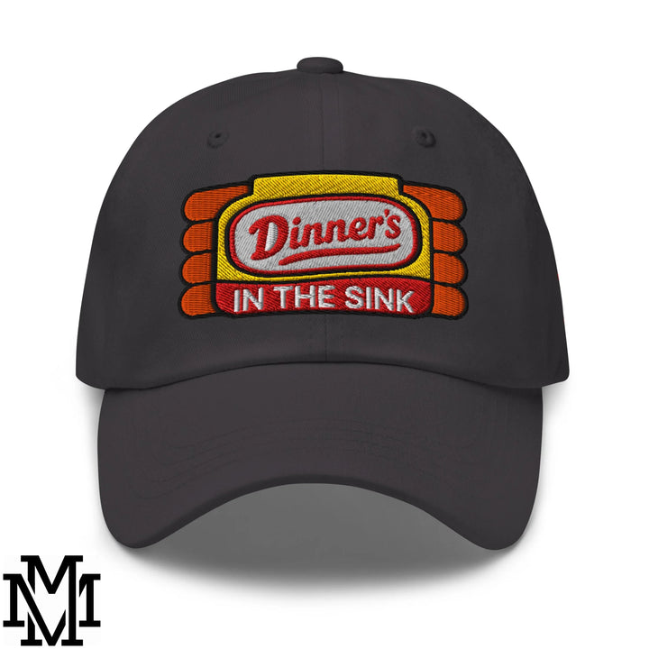 Dark gray unstructured dad hat with embroidered dinner’s in the sink patch in red white yellow and orange stripes