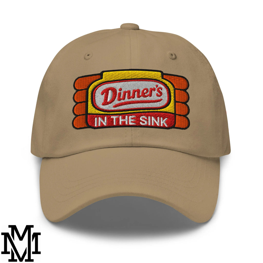 Beige unstructured dad hat featuring embroidered dinner’s in the sink red script logo on yellow and orange background
