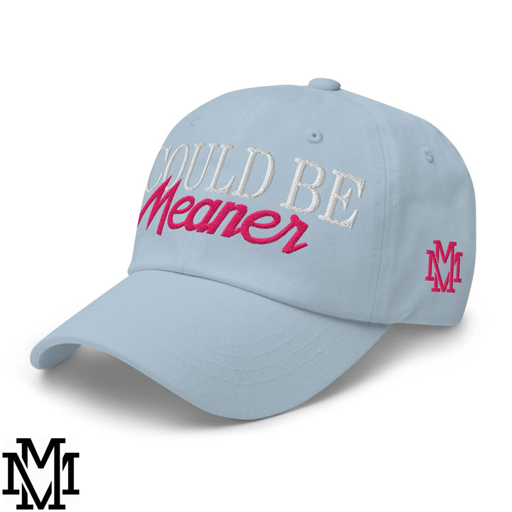 Light blue unstructured dad hat embroidered with could be meaner in white and pink thread with matching pink m logo