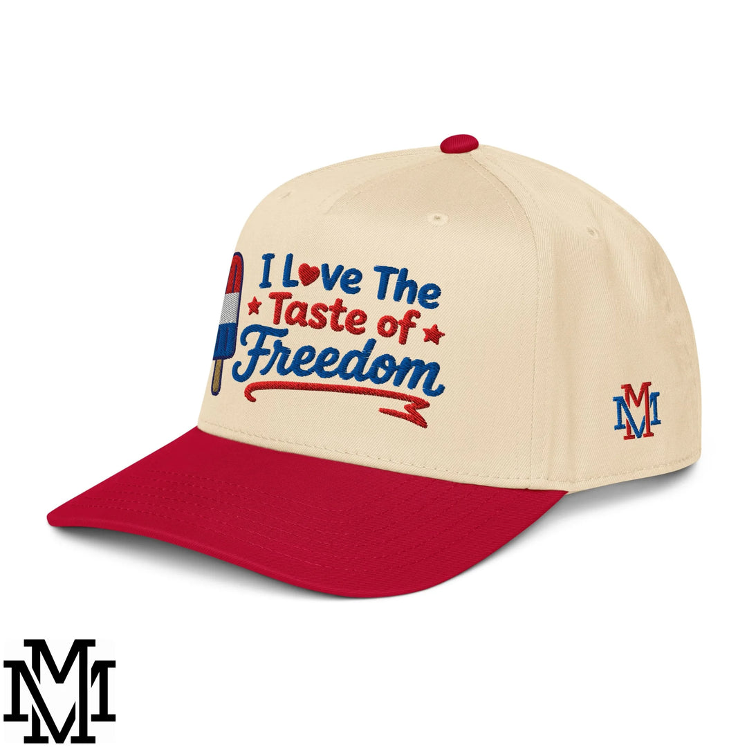 Cream-colored baseball snapback hat with red brim embroidered with i love the taste of freedom and patriotic designs
