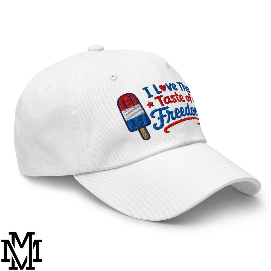 White unstructured dad hat with embroidered red white and blue popsicle and i love the taste of freedom text