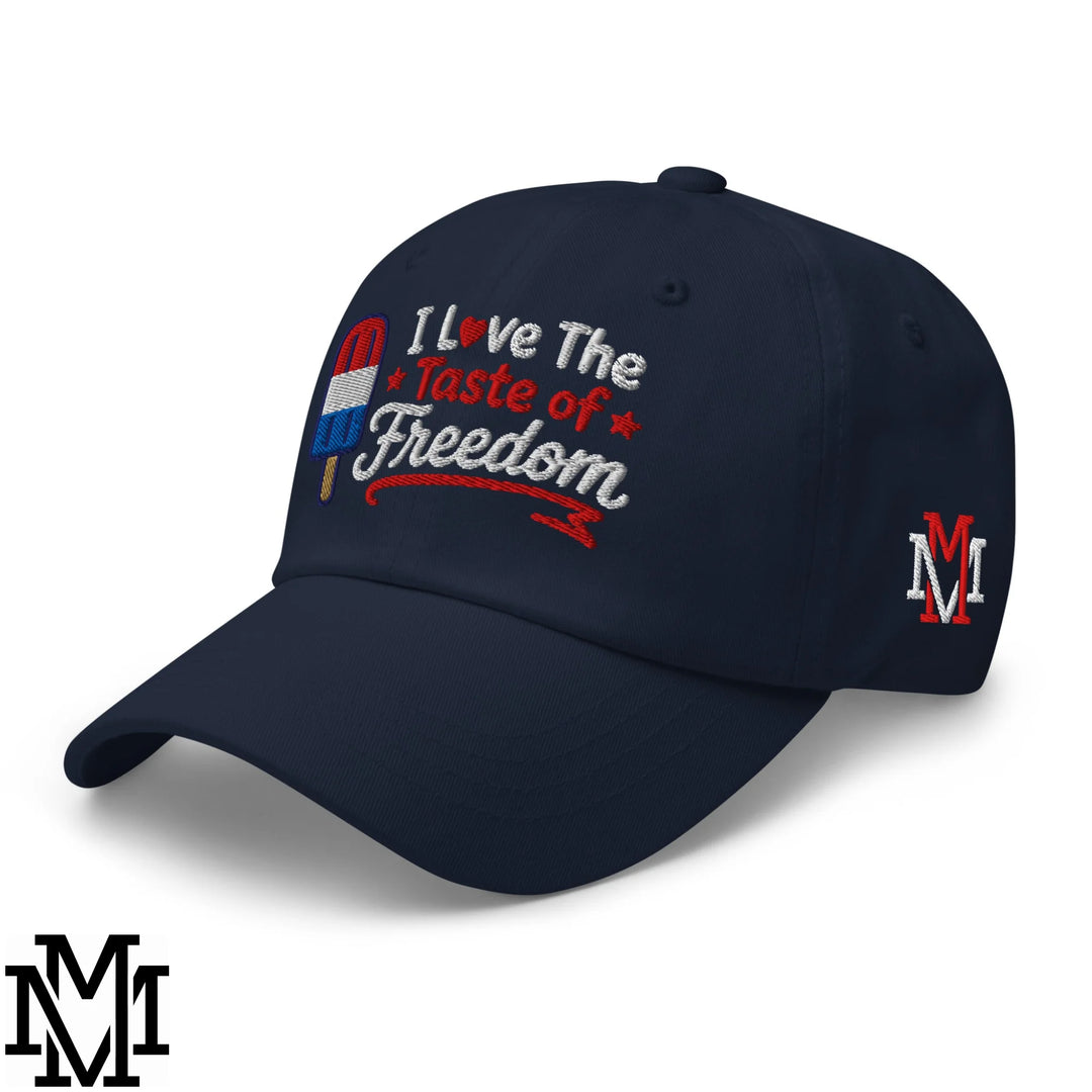Navy blue unstructured dad hat with embroidered red white and blue popsicle and silver i love the taste of freedom text
