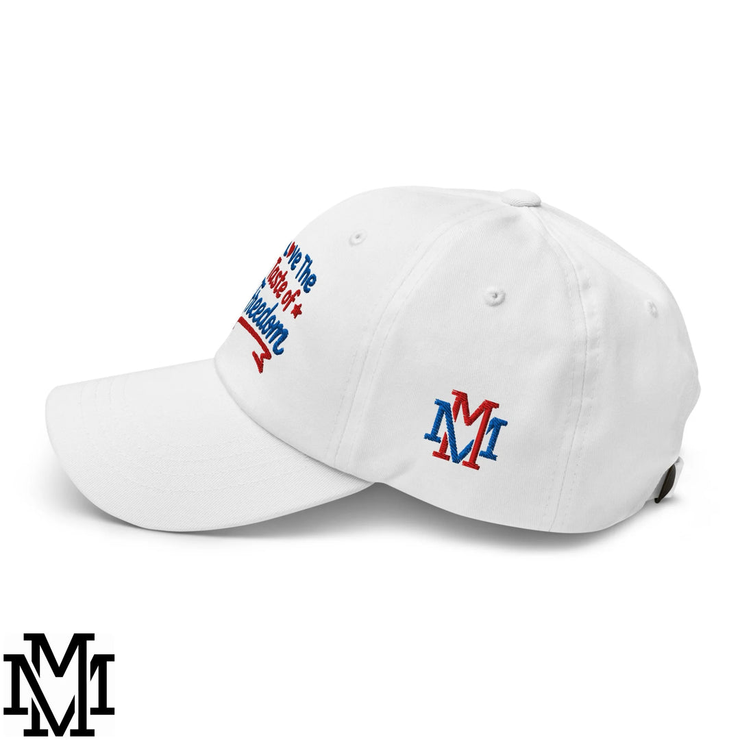 White unstructured dad hat with red and blue embroidered love the state of freedom text and matching m logo near back