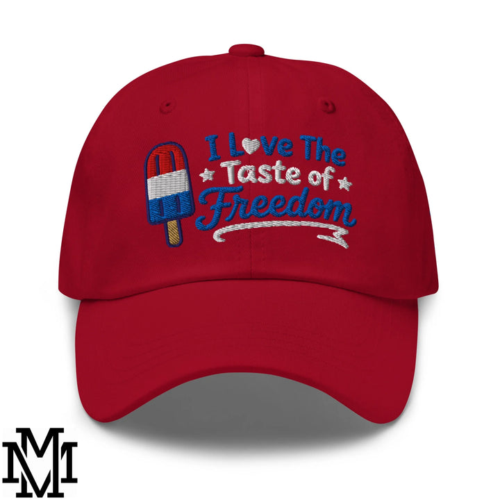 Red unstructured dad hat with patriotic popsicle embroidery and i love the taste of freedom phrase for 4th of july