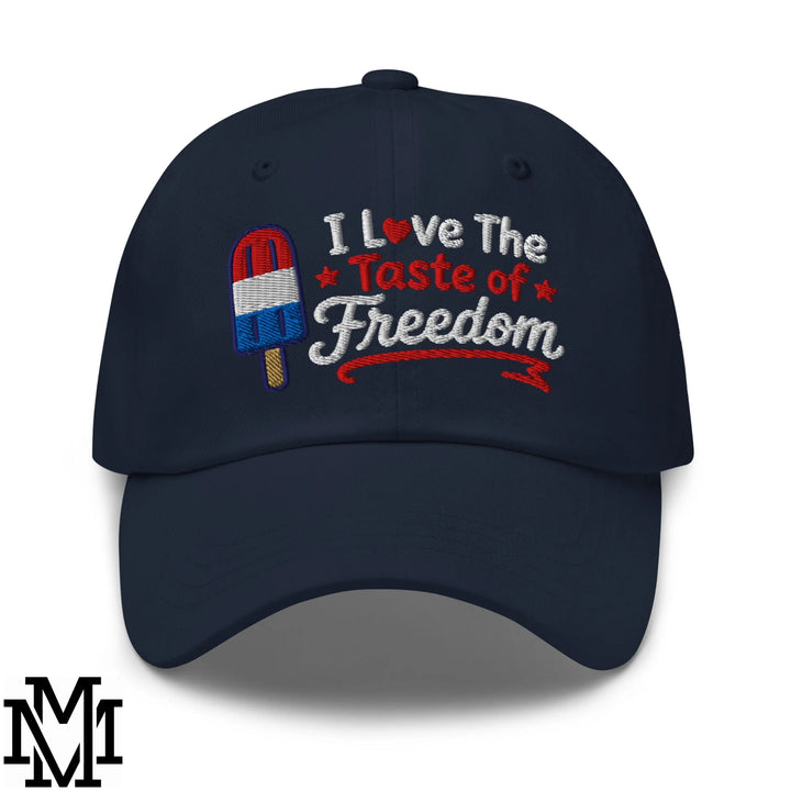 Navy blue unstructured dad hat with embroidered red white and blue popsicle and i love the taste of freedom text