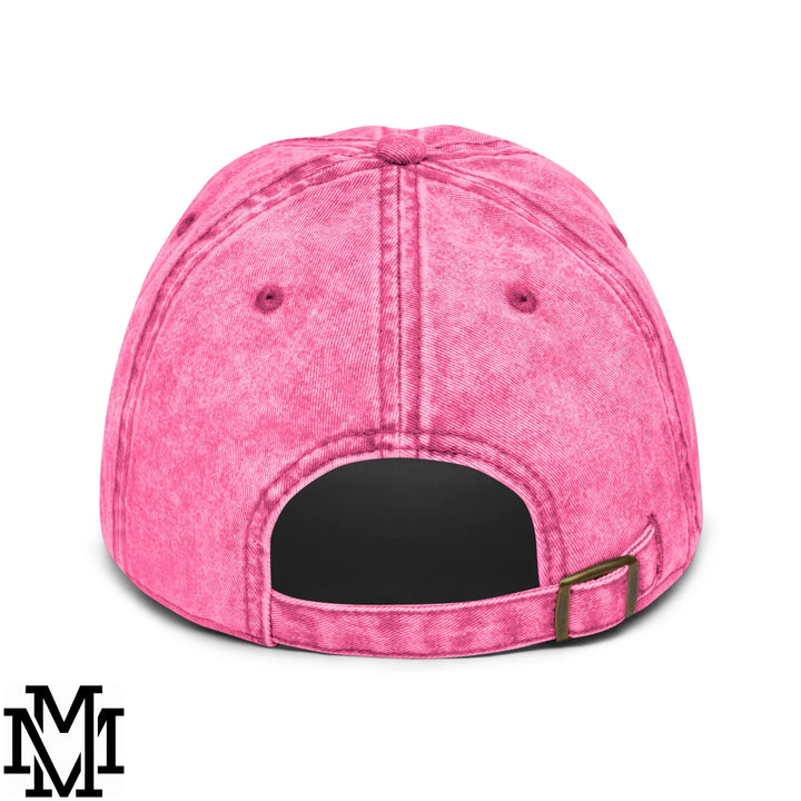 A vibrant pink denim latina power embroidered unstructured dad hat with faded texture and black adjustable strap back view