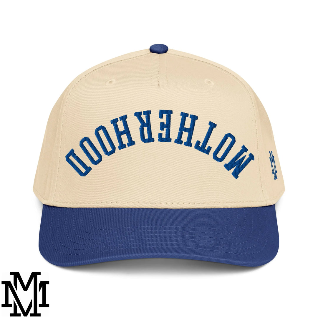 Beige and navy blue baseball snapback hat with motherhood embroidered in navy lettering on the front